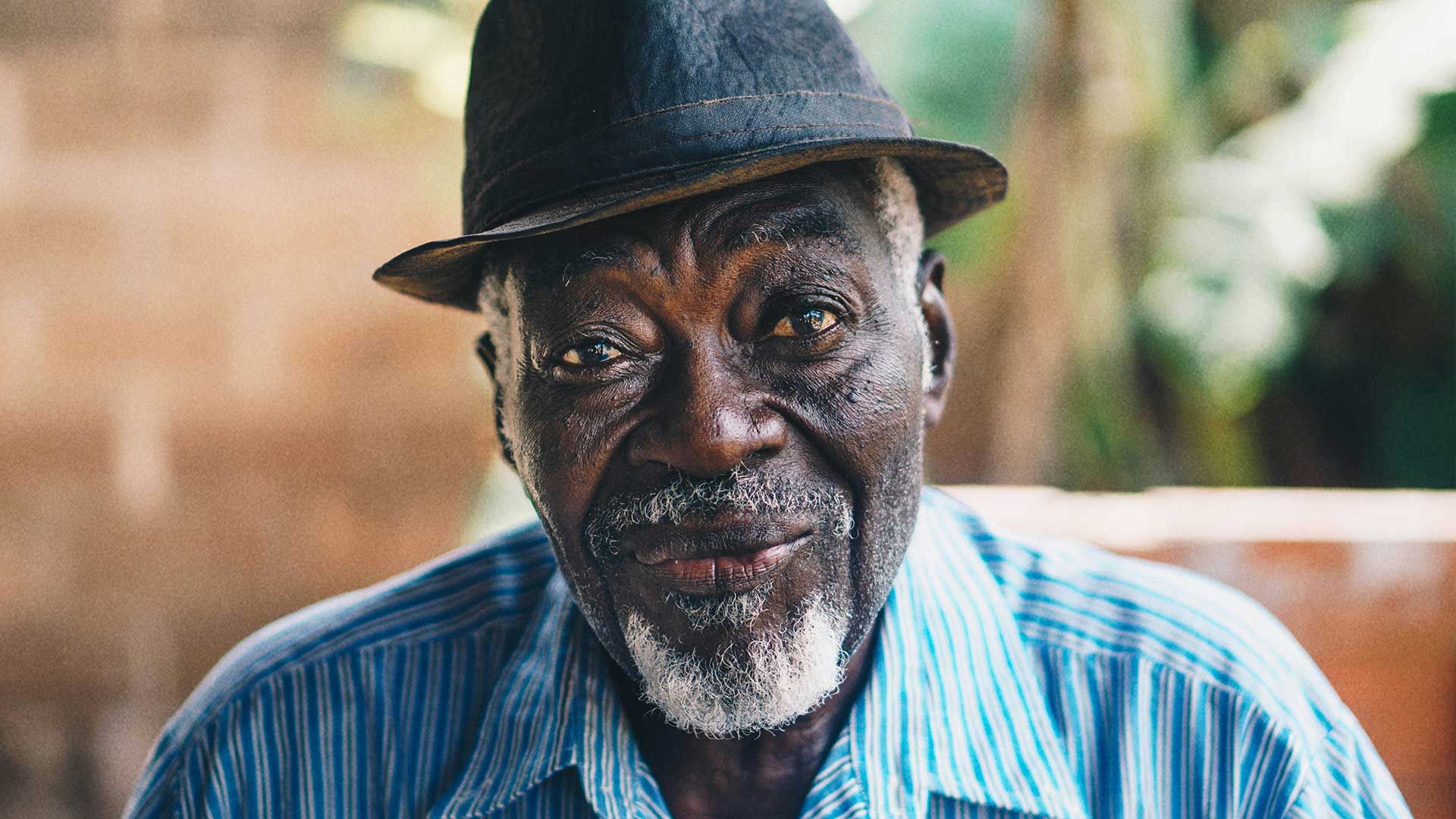 A Black man looking at the camera with a slight smile.